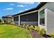 Close up of the screened-in lanai showcasing its design features and backyard view at 4795 Freccia Loop, Wesley Chapel, FL 33543