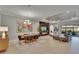 Open-concept living space with modern decor and an electric fireplace, seamlessly connecting living and dining areas at 4795 Freccia Loop, Wesley Chapel, FL 33543