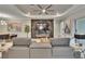 Modern living room with a sleek fireplace, mounted TV, and contemporary furnishings at 4795 Freccia Loop, Wesley Chapel, FL 33543