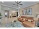 Open-concept living room with a leather sofa, view into the dining room, and neutral decor at 4795 Freccia Loop, Wesley Chapel, FL 33543