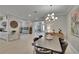 Open-concept living and dining areas with modern decor, neutral tones, and tile flooring at 4795 Freccia Loop, Wesley Chapel, FL 33543