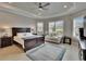 A spacious main bedroom boasts a tray ceiling, sitting area, and ample natural light at 4795 Freccia Loop, Wesley Chapel, FL 33543