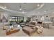 Open-concept living space with seamless transition from kitchen to living room and outdoor access at 4795 Freccia Loop, Wesley Chapel, FL 33543
