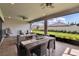 Covered patio with dining area and seating, offering an ideal outdoor living space with backyard views at 4795 Freccia Loop, Wesley Chapel, FL 33543