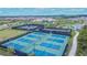 Aerial view showcasing the community's multiple tennis and pickleball courts at 4795 Freccia Loop, Wesley Chapel, FL 33543