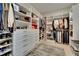 Organized walk-in closet with ample shelving, drawers, and hanging space for clothes and accessories at 4795 Freccia Loop, Wesley Chapel, FL 33543