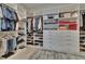 Spacious walk-in closet with custom shelving and drawers, providing ample storage space at 4795 Freccia Loop, Wesley Chapel, FL 33543