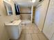 Well-lit bathroom featuring a shower-tub combo, vanity, and closet with built-in shelving at 4836 Daphne St, New Port Richey, FL 34652