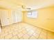 Bedroom featuring tile flooring, natural light, and closet storage space at 4836 Daphne St, New Port Richey, FL 34652
