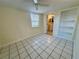 Cozy bedroom featuring tile floors and a well-lit bathroom at 4836 Daphne St, New Port Richey, FL 34652