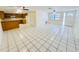Open-concept floor plan featuring tile flooring that connects the living room to the kitchen at 4836 Daphne St, New Port Richey, FL 34652