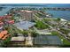 Aerial view of the property showcasing the building, parking, tennis courts, and waterfront access at 4900 Brittany S Dr # 613, St Petersburg, FL 33715