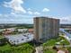 Aerial shot of a tall condo building, parking lot and views of the water at 4900 Brittany S Dr # 613, St Petersburg, FL 33715
