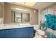 Bathroom features a blue vanity with sink, toilet, and themed shower curtain at 4900 Brittany S Dr # 613, St Petersburg, FL 33715