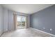 Bedroom with curtains and sliding glass door to a balcony overlooking the city at 4900 Brittany S Dr # 613, St Petersburg, FL 33715