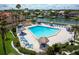 Aerial view of a spacious community pool area with seating and lush landscaping near the water at 4900 Brittany S Dr # 613, St Petersburg, FL 33715