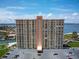 Stunning exterior view of a tall building showcasing the architecture, balconies, and parking area with beautiful landscaping at 4900 Brittany S Dr # 613, St Petersburg, FL 33715