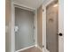 Hallway with a pantry featuring frosted glass door and an alternate access door at 4900 Brittany S Dr # 613, St Petersburg, FL 33715