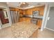 Well-lit kitchen boasts stainless steel appliances, granite countertops, a functional center island, and a tile floor at 4900 Brittany S Dr # 613, St Petersburg, FL 33715