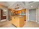 Bright kitchen featuring stainless steel appliances, granite countertops, central island, and tile flooring at 4900 Brittany S Dr # 613, St Petersburg, FL 33715
