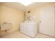 Bright laundry room includes washer, dryer, sink, and plenty of space at 4900 Brittany S Dr # 613, St Petersburg, FL 33715