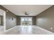 Living room with ceiling fan features sliding glass doors to a balcony overlooking the city at 4900 Brittany S Dr # 613, St Petersburg, FL 33715