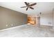 Open living room with ceiling fan flows into the kitchen with modern appliances at 4900 Brittany S Dr # 613, St Petersburg, FL 33715