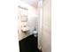 Simple bathroom featuring a toilet, sink and mirror with white tiled walls at 4902 Panorama Ave, Holiday, FL 34690
