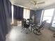 Bright sun room with table, chairs, ceiling fan and large windows at 4902 Panorama Ave, Holiday, FL 34690