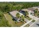 An aerial view of a single-Gathering home showcasing its well-manicured lawn and a treed backyard at 5102 Coastal Scene Dr, Apollo Beach, FL 33572