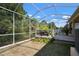 Screened patio with wood deck for entertaining with outdoor seating and lush green grass at 5102 Coastal Scene Dr, Apollo Beach, FL 33572
