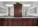 Bright bathroom featuring granite counters, dual sinks, and matching mirrors at 5102 Coastal Scene Dr, Apollo Beach, FL 33572