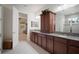 Bright bathroom featuring granite counters, dual sinks, enclosed shower and walk-in closet at 5102 Coastal Scene Dr, Apollo Beach, FL 33572