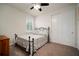 Neutral bedroom featuring a ceiling fan, window, and sliding door closet at 5102 Coastal Scene Dr, Apollo Beach, FL 33572