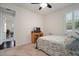 Neutral bedroom features a ceiling fan, window, and view to office space at 5102 Coastal Scene Dr, Apollo Beach, FL 33572