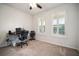 Neutral bedroom features shuttered windows, carpeted floors, ceiling fan, and functional layout, perfect for working from home at 5102 Coastal Scene Dr, Apollo Beach, FL 33572