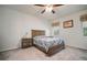 Neutral bedroom featuring a ceiling fan, window, and two matching nightstands at 5102 Coastal Scene Dr, Apollo Beach, FL 33572