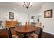The dining room flows into an open living space, featuring a chandelier, wood floors, and a sideboard at 5102 Coastal Scene Dr, Apollo Beach, FL 33572