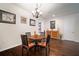 Cozy dining room featuring a chandelier, hardwood floors, and tasteful decor, perfect for Gathering meals at 5102 Coastal Scene Dr, Apollo Beach, FL 33572