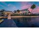 Waterfront home featuring a private dock, lush landscaping, and a charming coastal architectural design at 5102 Coastal Scene Dr, Apollo Beach, FL 33572
