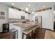 Bright kitchen featuring a large island with seating, granite countertops, and stainless steel appliances at 5102 Coastal Scene Dr, Apollo Beach, FL 33572