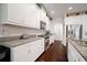 Well-lit kitchen with granite countertops, stainless steel appliances, and ample white cabinetry at 5102 Coastal Scene Dr, Apollo Beach, FL 33572