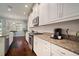 Modern kitchen with granite countertops, stainless steel appliances, and stylish white cabinetry at 5102 Coastal Scene Dr, Apollo Beach, FL 33572