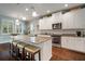 Spacious kitchen featuring granite counters, stainless steel appliances, a center island, and ample cabinet space at 5102 Coastal Scene Dr, Apollo Beach, FL 33572