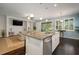 Kitchen with a large center island, stainless appliances, and open view to the living room at 5102 Coastal Scene Dr, Apollo Beach, FL 33572