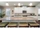 Bright kitchen featuring a large island with seating, granite countertops, and stainless steel appliances at 5102 Coastal Scene Dr, Apollo Beach, FL 33572