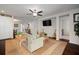 Spacious living room with comfortable seating, modern ceiling fan, and seamless flow into other areas at 5102 Coastal Scene Dr, Apollo Beach, FL 33572