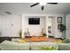 Cozy living room with comfortable seating, entertainment center, and seamless flow into other areas at 5102 Coastal Scene Dr, Apollo Beach, FL 33572