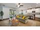 Open concept living room with seamless transition into the kitchen, perfect for entertaining and Gathering gatherings at 5102 Coastal Scene Dr, Apollo Beach, FL 33572