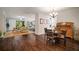 Open floor plan showcases the dining and living area connected by hardwood floors and natural light at 5102 Coastal Scene Dr, Apollo Beach, FL 33572